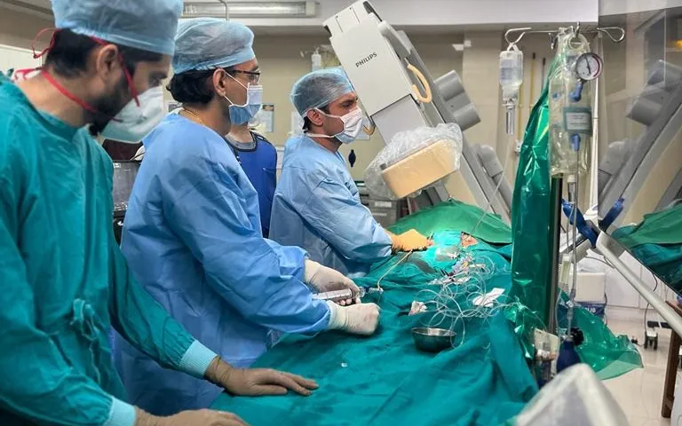 Doctors working at the procedure table in the catheterisation lab